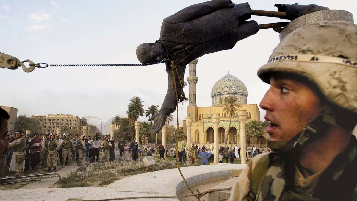 [File] Iraqi civilians and U.S. soldiers pull down a statue of Saddam Hussein in downtown Baghdad, in this April 9,2023 photo | AP