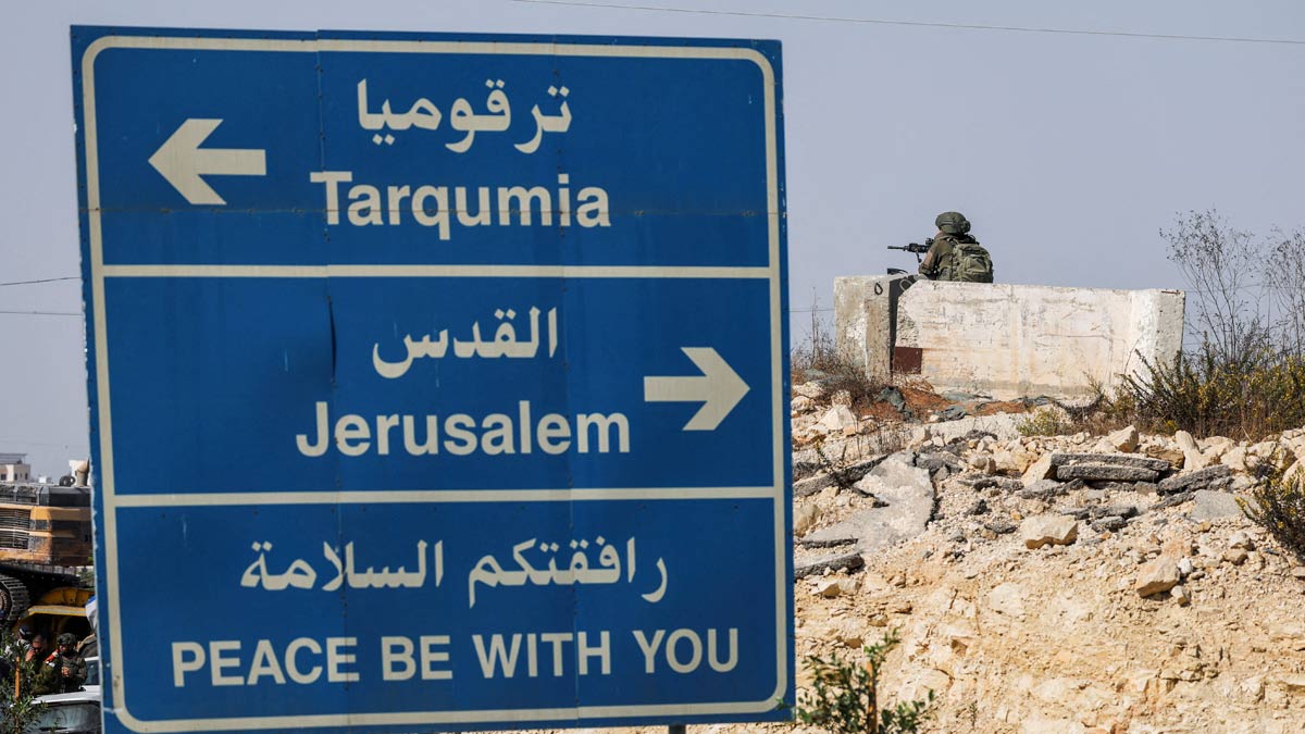 A member of Israeli forces guards the area on the day Israeli Prime Minister Benjamin Netanyahu visits the site following a shooting in Hebron in the Israeli-occupied West Bank | Reuters