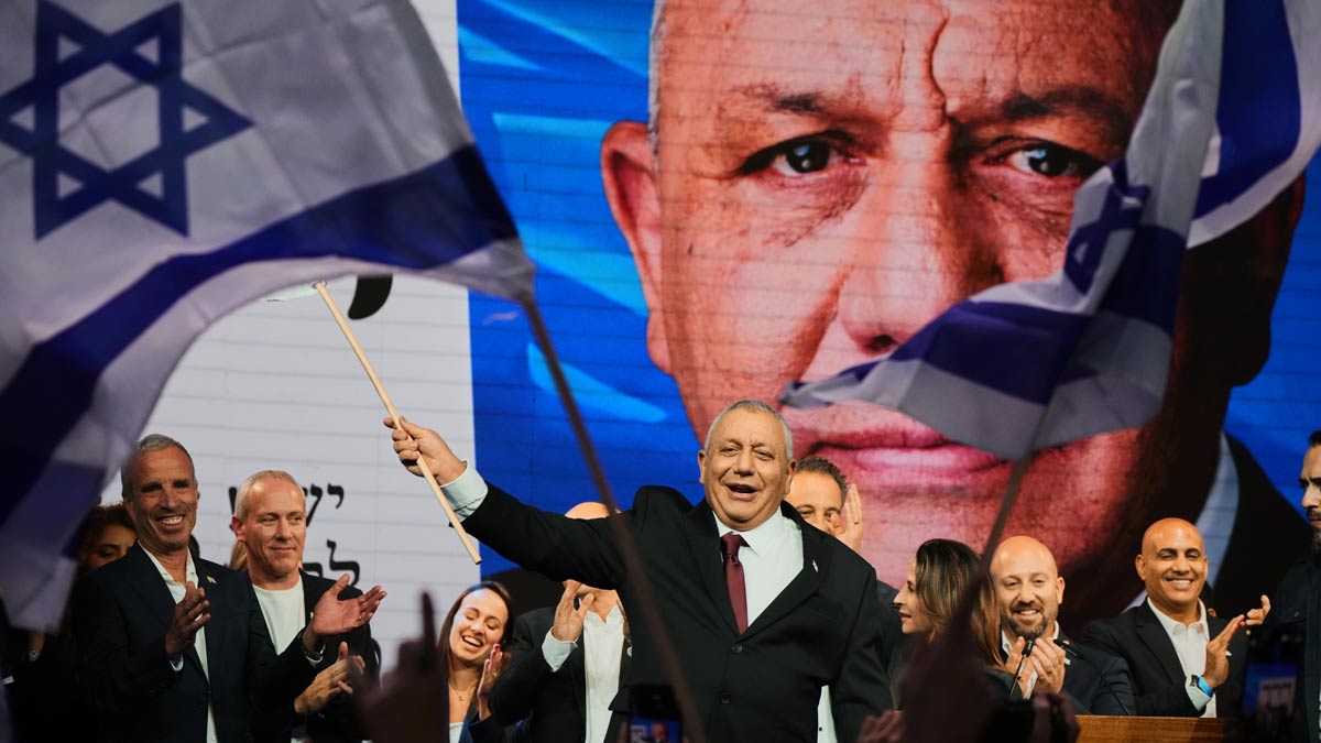 Gadi Eisenkot, leader of the Yashar party, waves an Israeli flag onstage following the release of the first exit poll results in Israel's general election in Tel Aviv on October 28, 2026 | AP