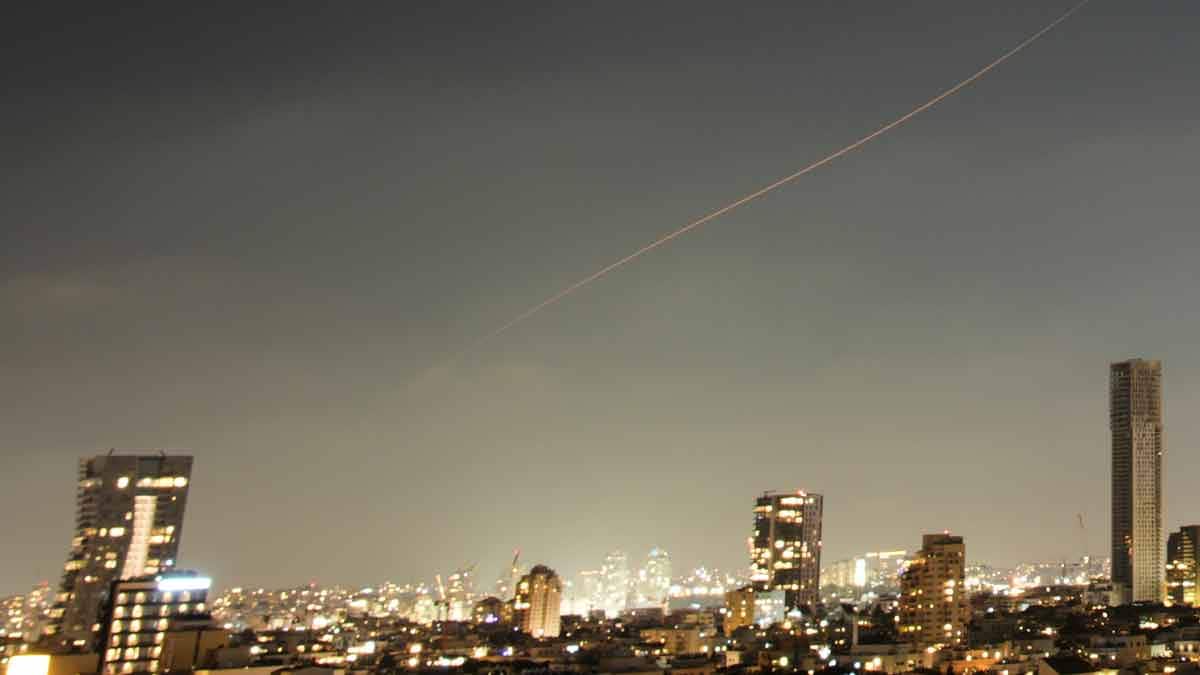 A projectile streaks through the sky over central Israel during an Iranian missile attack | AP