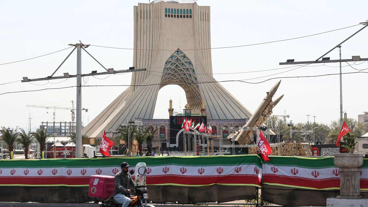A man rides past Iranian-made Zolfaghar missiles displayed at Azadi Square in Tehran on July 24 | AFP
