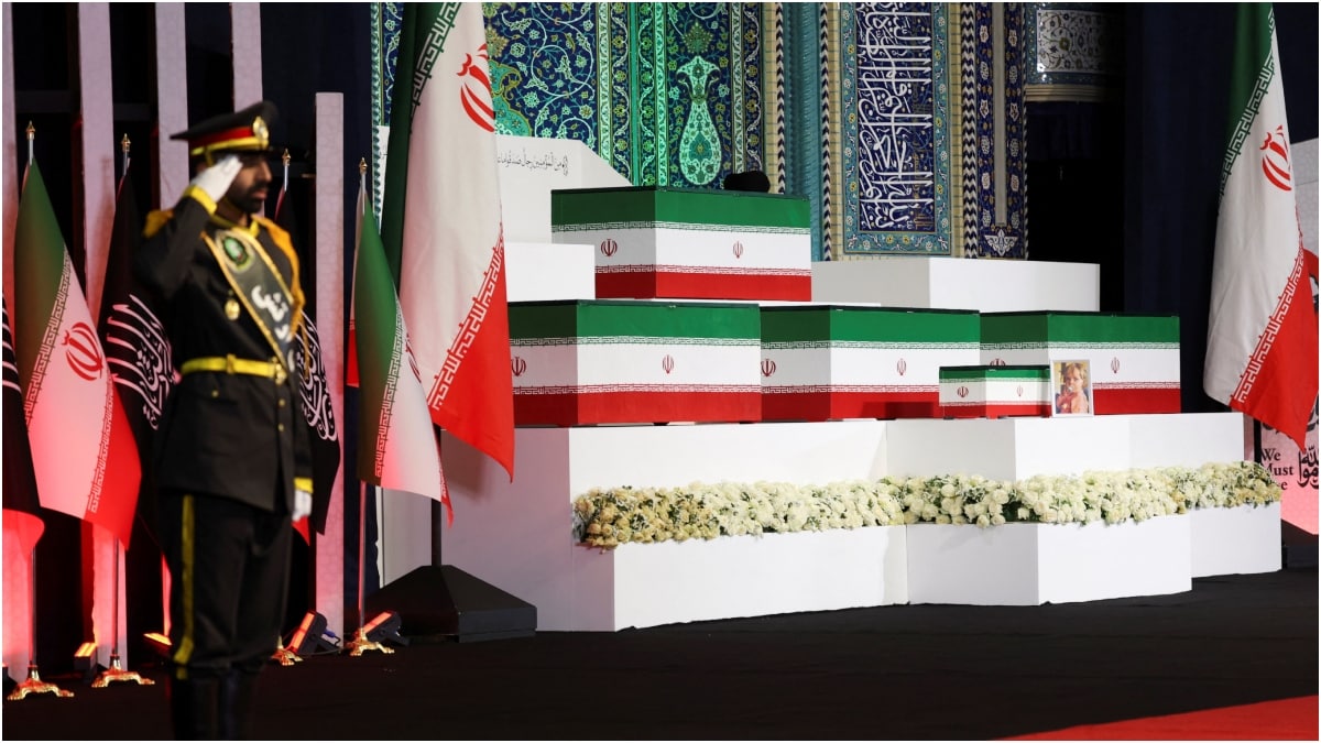 A member of the Iranian army salutes as the coffins of Iran's late Supreme Leader Ayatollah Ali Khamenei and his family members are displayed on the day international delegates participate in a farewell ceremony | Reuters