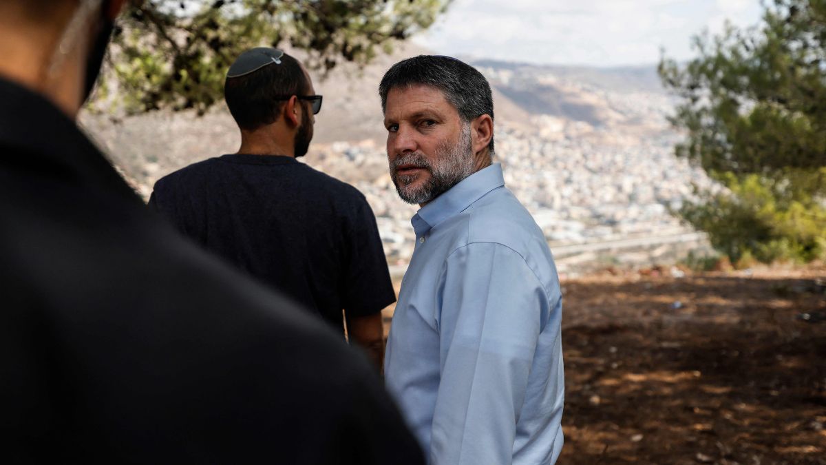 Far-right Finance Minister and leader of the Religious Zionist Party (HaTzionut HaDatit), Bezalel Smotrich, looks on as he attends a party meeting organised on a hill overlooking the northern Arab-Israeli town of Majd al-Krum | AFP 