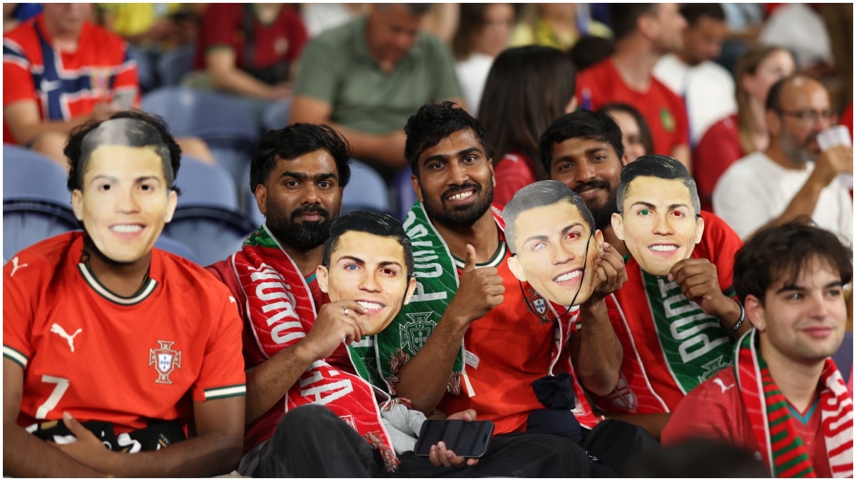Fans on the stands holds masks of Portugal's Cristiano Ronaldo during a Nations League game | AP