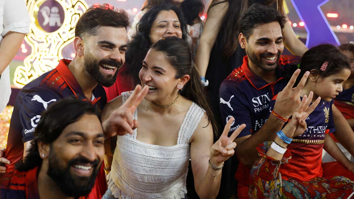 Royal Challengers Bengaluru's Krunal Pandya, Virat Kohli and Bhuvneshwar Kumar celebrate with their families after winning the IPL | Reuters
