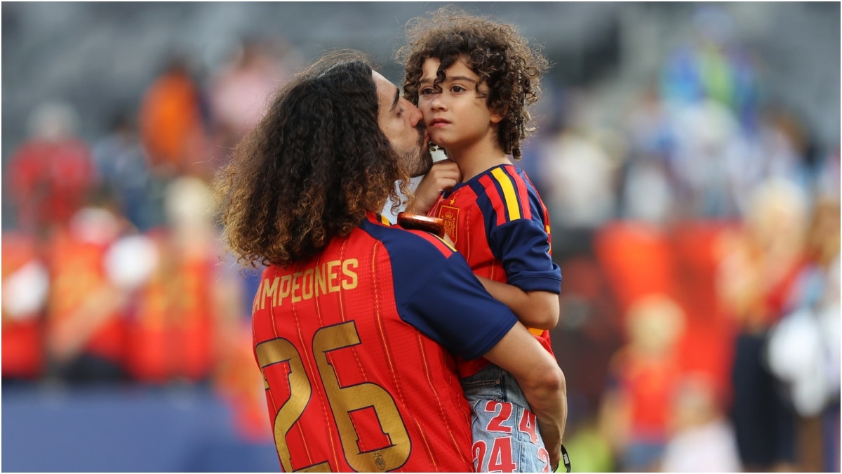 Spain's Marc Cucurella holds a kid after the FIFA World Cup final | AP