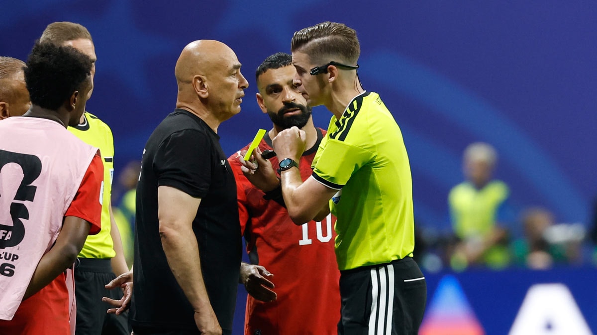 Egypt head coach Hossam Hassan is shown a yellow card by referee Francois Letexier | AP
