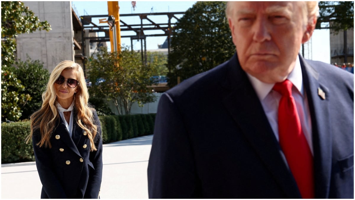 Katie Zacharia stands behind US President Donald Trump | Reuters
