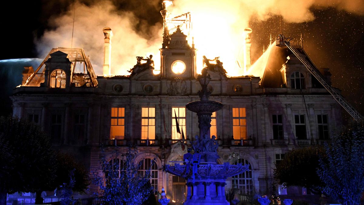 A fire burning and destroying the city hall after a group of individuals forced entry into the building during ongoing protest action against the "high cost of living", in Limoges, central France | AFP