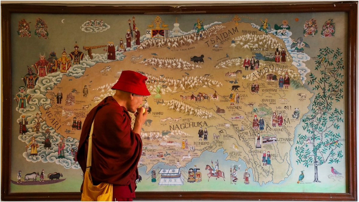 A monk looks at an old Tibet map on day 2 of Norbulinga festival 2026 in Dharmshala | PTI