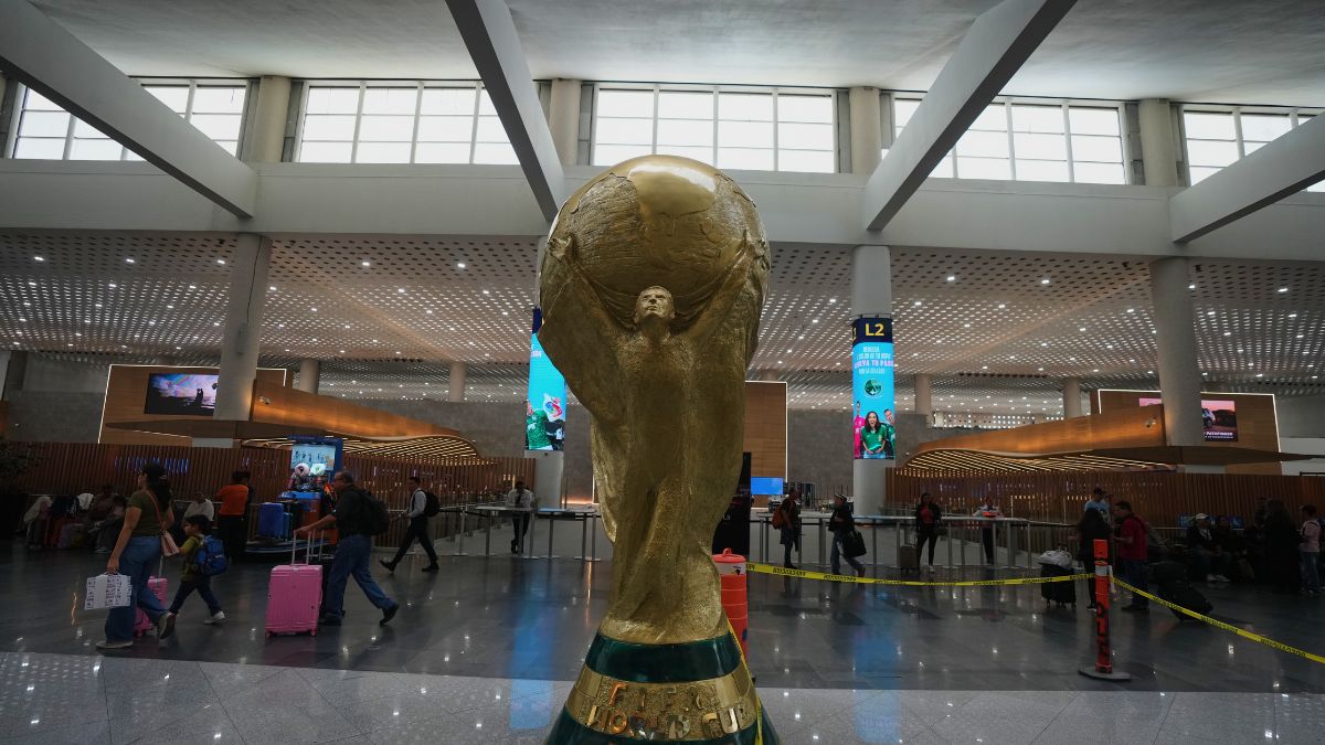 Passengers walk past a sculpture of the World Cup trophy during a guided media tour of the renovation work at Benito Jurez International Airport, in preparation for the 2026 World Cup in Mexico City | AP