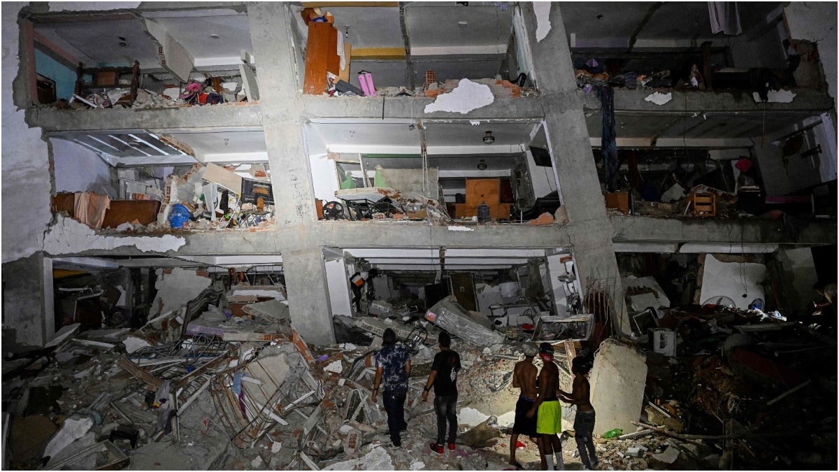 People stand in the rubble near a damaged building following an earthquake in Catia La Mar, La Guaira State, some 30kms north-west of Caracas | AFP