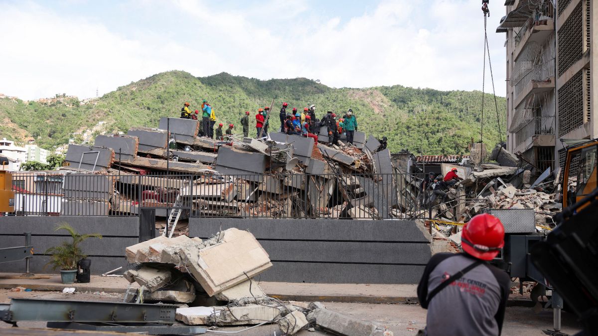 People search for casualties amid the rubble of a collapsed building in the aftermath of earthquakes in Caracas, Venezuela | Reuters