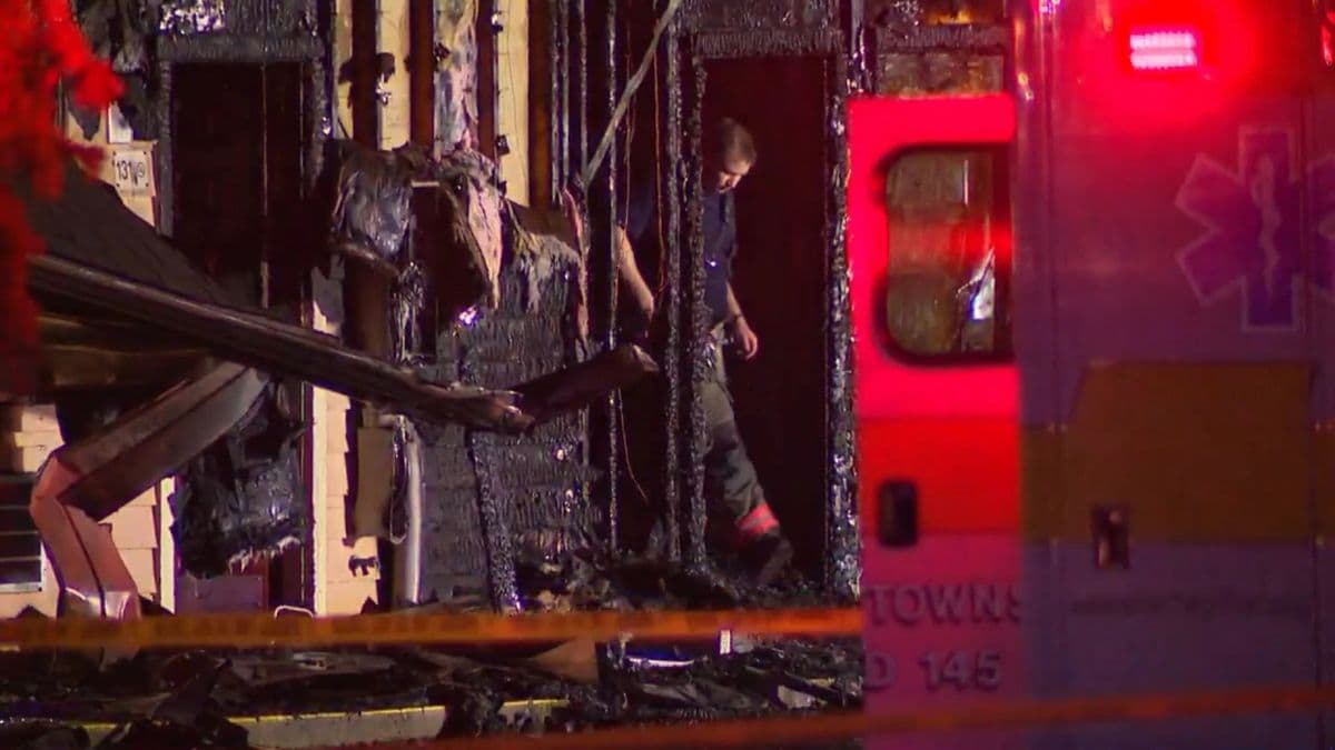 A firefighter exits the charred remains of the Econo Lodge motel in Wooster, Ohio | AP