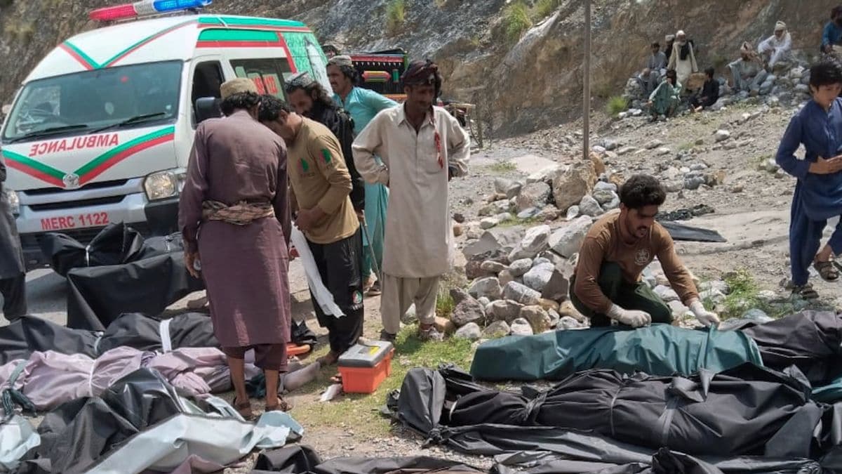 Rescue workers and volunteers cover bodies after recovering them after a passenger bus plunged from a highway into a rocky ravine at Dhanasar, near the Balochistan-KP border, on July 3, 2026 | AP