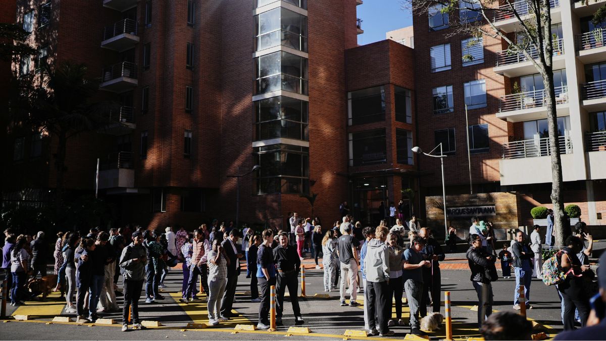 People stand outside their homes after a quake was felt in Bogota, Colombia | AP