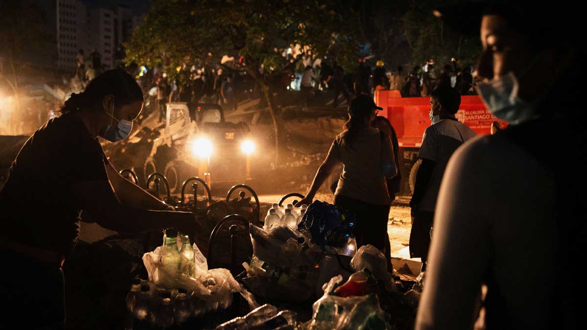Supplies are organised next to the site of a collapsed building as recovery efforts continue at night following an earthquake, in Cali, Colombia | Reuters