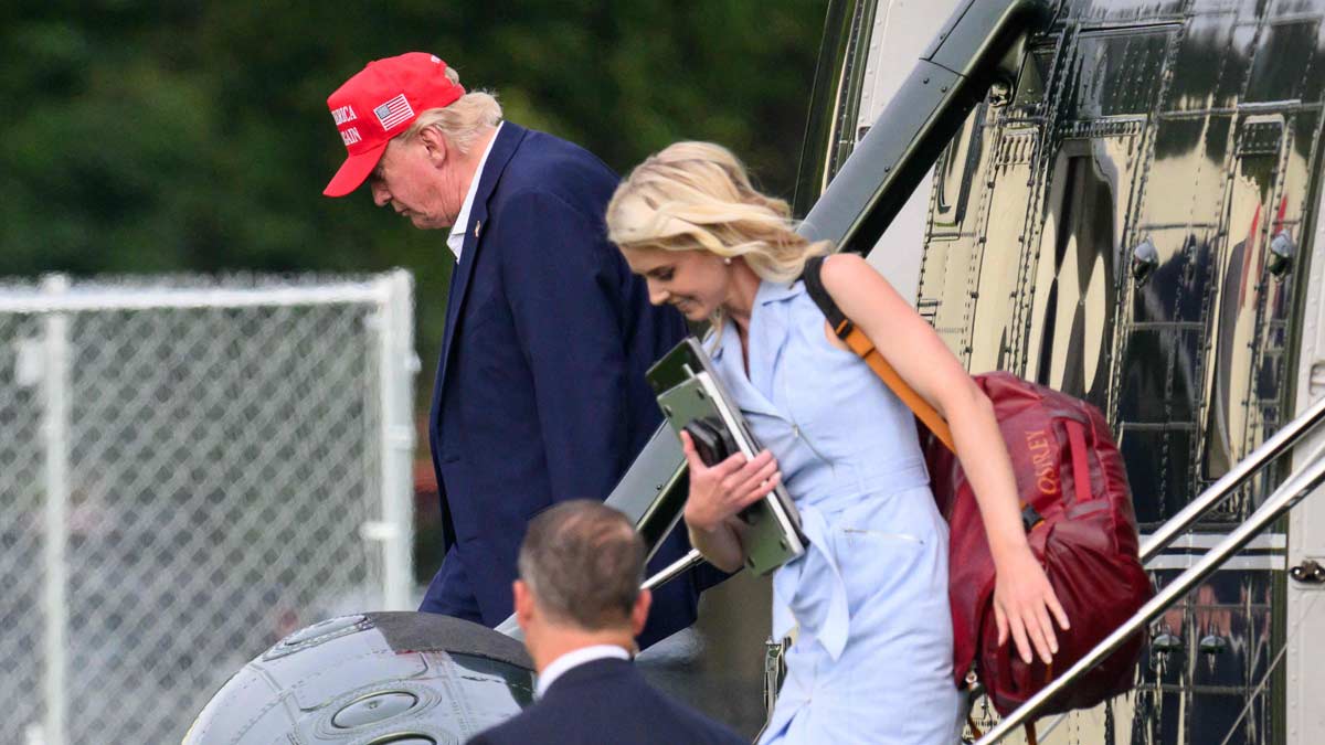 US President Donald Trump and aide Natalie Harp (R) exit Marine One on the Ellipse near the White House on August 16, 2026 | AFP