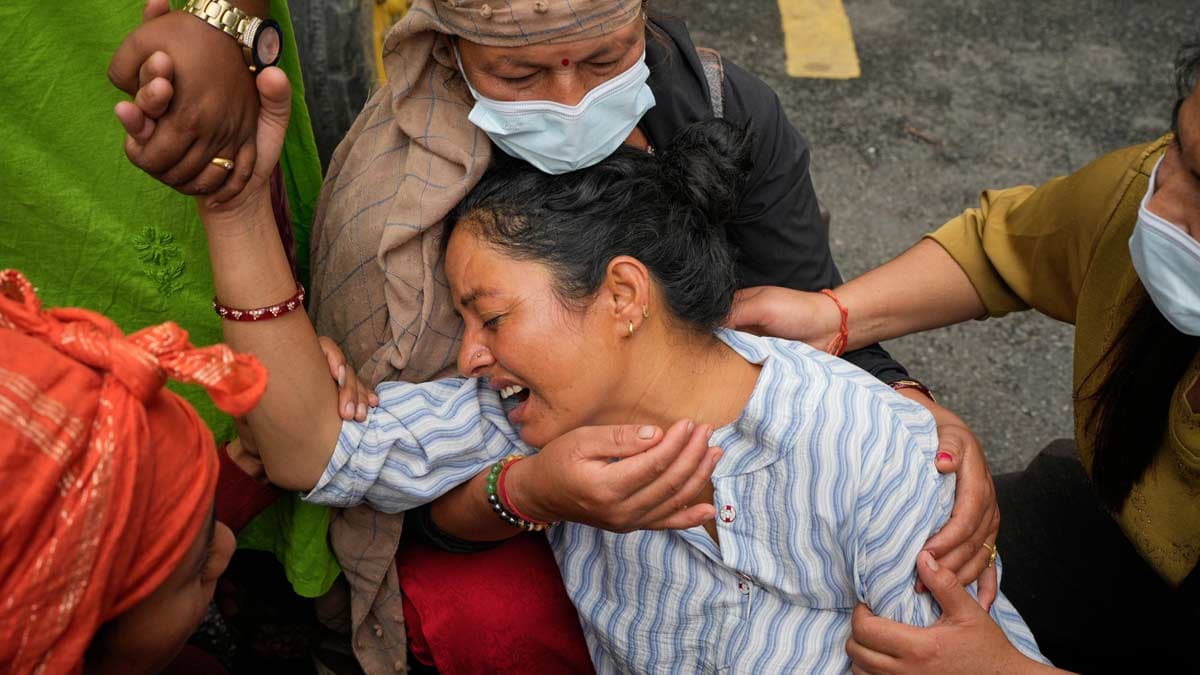 Relatives console Muna Khadka, centre, who lost her son Aayush Khada in flash floods | AP