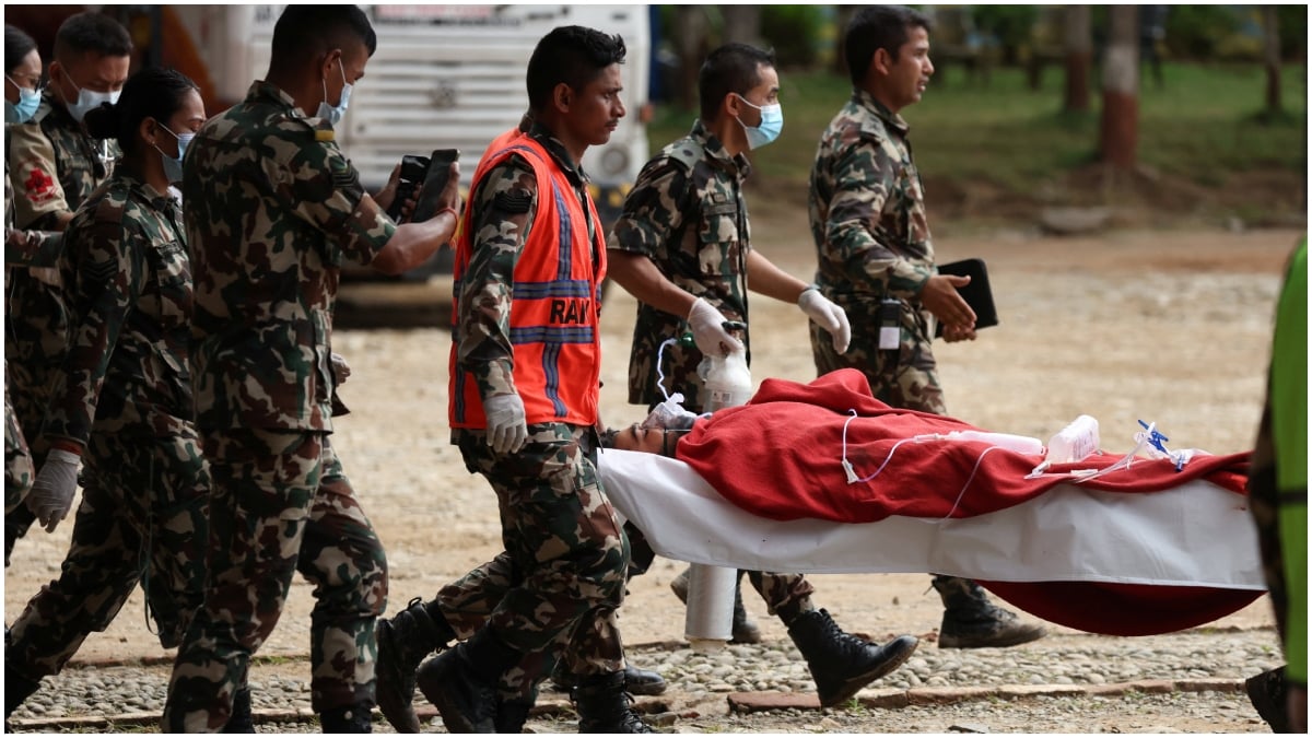 Anil shah, a survivor rescued from a tunnel of the Upper Trishuli 3A hydropower project nine days after the deadly flash floods and a mudslide, is being carried to be air lifted to Kathmandu | Reuters