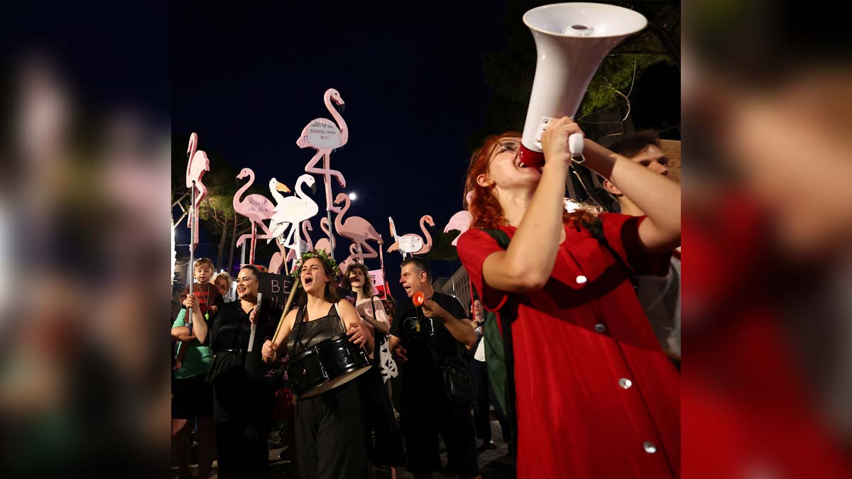 Protesters hold flamingo-shaped placards as they demonstrate against the government, following weeks of protests against a planned luxury resort backed by a company linked to Jared Kushner, the son-in-law of U.S. President Donald Trump, on an environmentally sensitive part of the Adriatic coast, in Tirana, Albania, June 26, 2026. REUTERS/Florion Goga