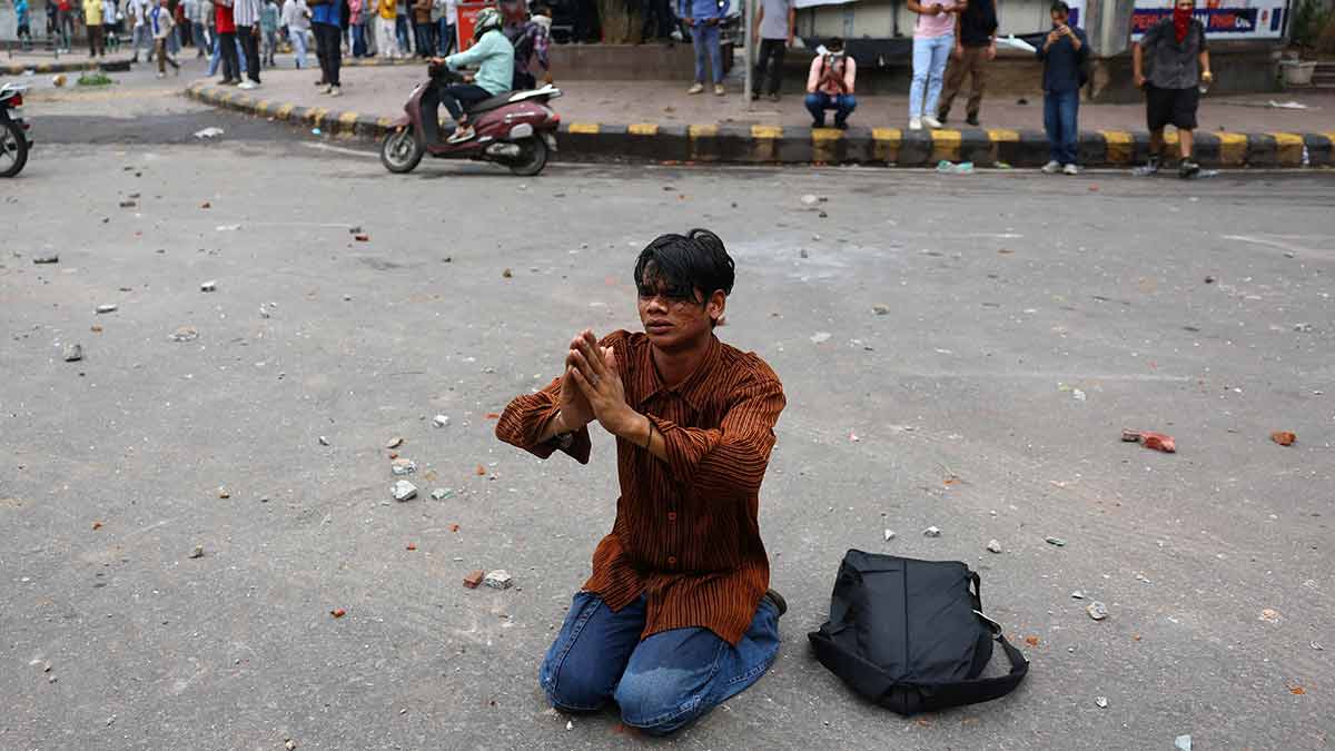 A protester pleads with police to not take action at the CJP march in Delhi | Reuters