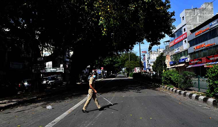 A policeman patrols the street in Rohini | Sanjay Ahlawat