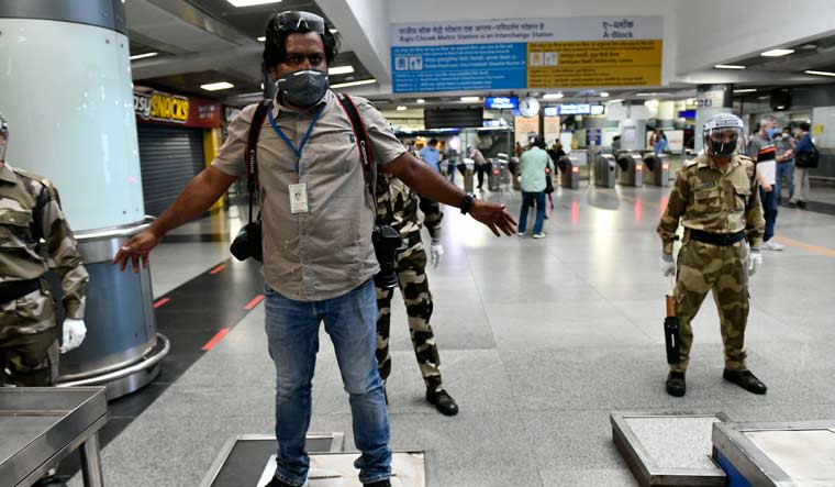 Security personnel at the Delhi Metro frisking a member of the Press | Sanjay Ahlawat