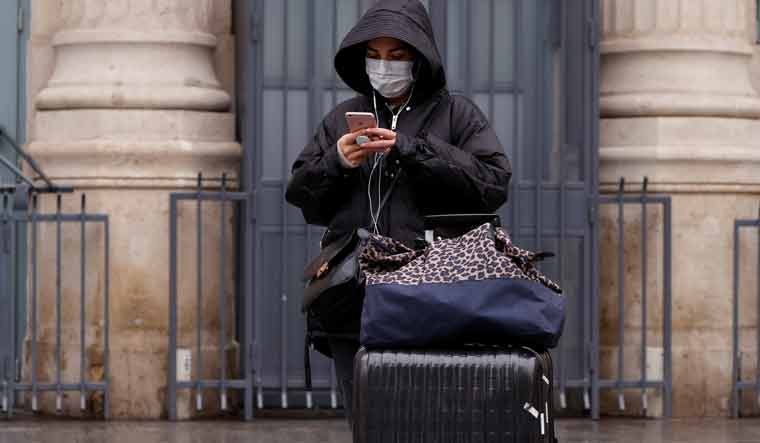 A woman wearing a protective face mask is seen at Gare du Nord railway station in Paris | Reuters