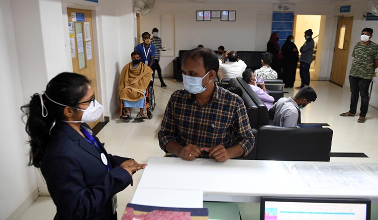 Here to help: Ayu Mitra, the patient relationship officer of Ayu Health, helping a patient at North Bangalore Hospital in Bengaluru | Bhanu Prakash Chandra