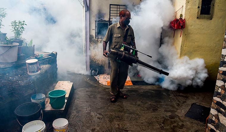 Smoke out: An anti-malaria fumigation drive inside a slum in Mumbai | AFP