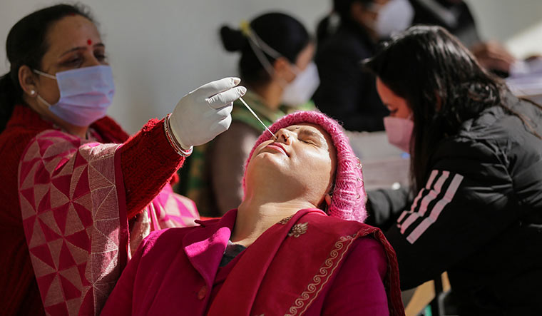Living with the virus: A woman gets tested for Covid-19 in Jammu | PTI