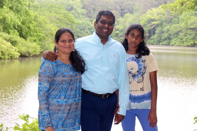 Family man: Amara with his wife, Lakshmi Chennareddi, and their daughter, Isha.