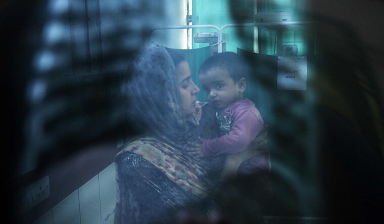 Trouble in the air: A doctor (not pictured) examines the X-ray of a child with breathing difficulties at the emergency ward of the government-run Chacha Nehru Bal Chikitsalaya, New Delhi | AFP