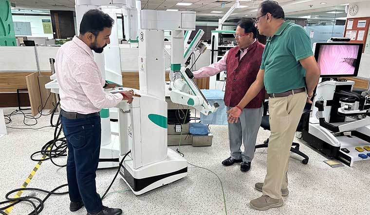 The man and the machine: Dr Sudhir Prem Srivastava (in red), founder-chairman and CEO of SS Innovations, at one of the company's labs.