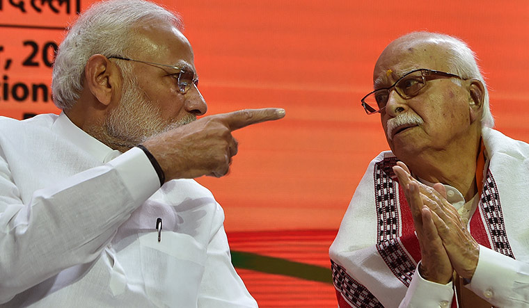[File] Prime Minister Narendra Modi interacts with L.K. Advani, the senior-most member of the BJP’s top advisory body Margdarshak Mandal, at the party’s national executive in New Delhi | J. Suresh