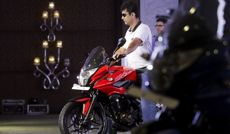 Joint race | Rajiv Bajaj, managing director of Bajaj Auto Ltd, on a Pulsar AS 200 motorbike. Bajaj Auto has tied up with British bike maker Triumph to develop a new range of mid-capacity motorcycles | Reuters