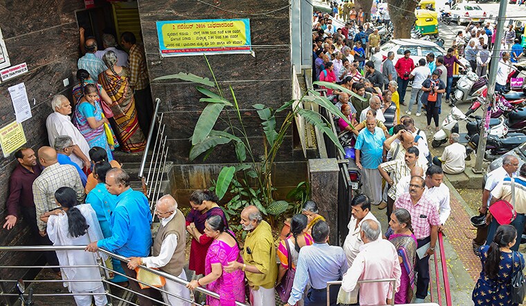 Bengaluru: Depositors stand in queue to withdraw money from Sri Guru Raghavendra Sahakara Bank in Bengaluru, Tuesday, Jan.14, 2020. The Reserve Bank of India (RBI) has curbed  Sri Guru Raghavendra Sahakara Bank from doing business with immediate effect for alleged irregularities in transactions. (PTI Photo/Shailendra Bhojak)(PTI1_14_2020_000051B)
