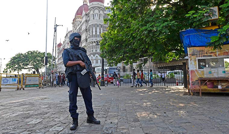 On guard: A Force One commando outside the Taj hotel.