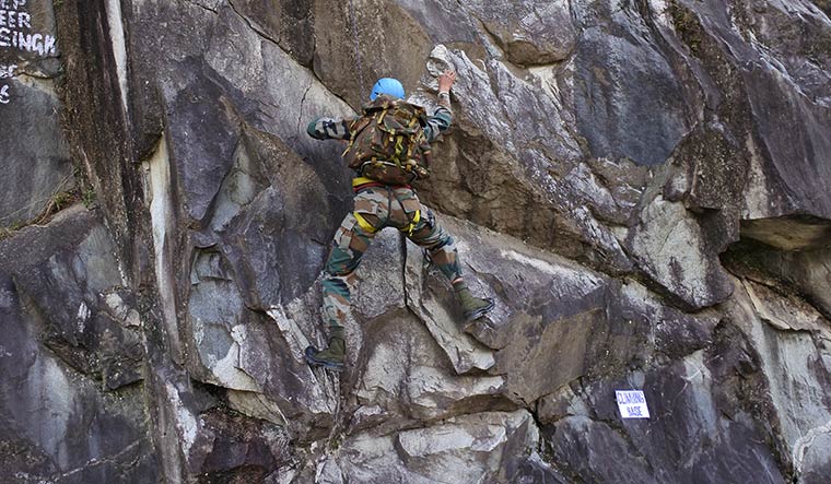 All in a day’s work: An Indian infantryman climbs a rock during a long-range patrol duty | R. Prasannan
