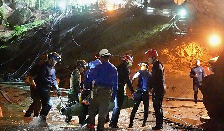 Into the light: An undated photo released by the Royal Thai Navy on July 11 shows a member of the Wild Boars team being moved on a stretcher during the rescue operation | AFP