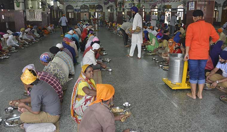 Spoonful of succour: Food being served at the langar hall at the Golden Temple in Amritsar | Arvind Jain