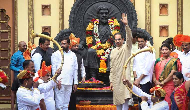 Victor, at last: Uddhav Thackeray and son Aaditya (to his left) greeting party workers after paying tribute to the statue of Chhatrapati Shivaji Maharaj in Thane | PTI