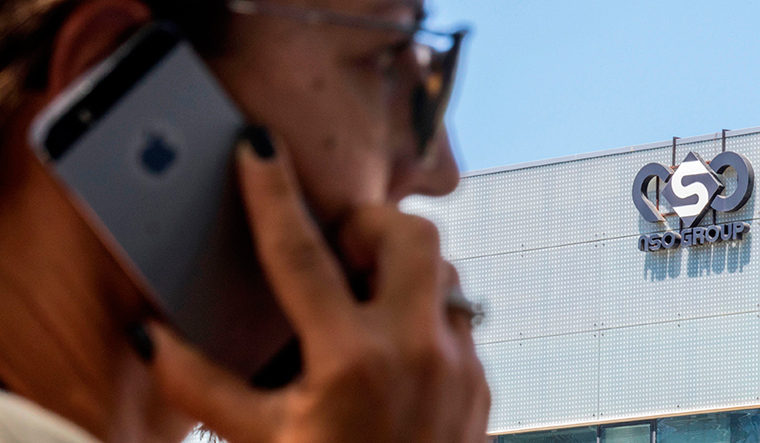 Eye of the storm: A person using a cellphone near the NSO Group headquarters in Herzliya, Israel | AFP