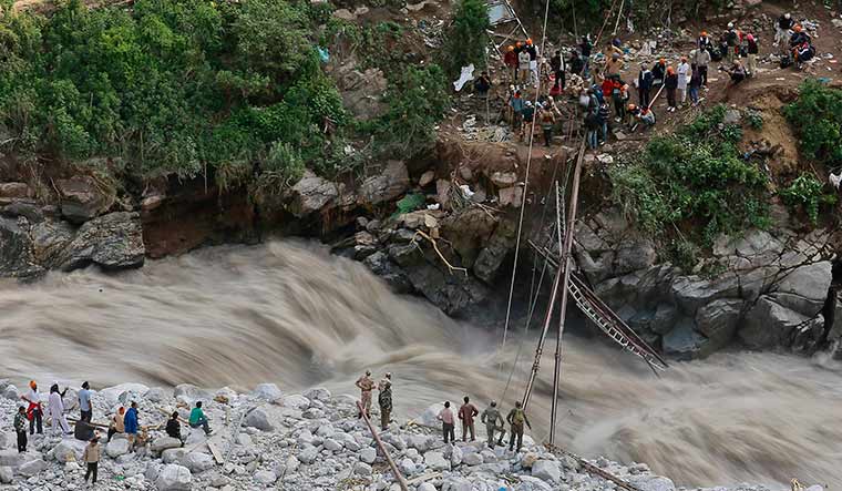 Soldiers attempt to repair a footbridge over the Alaknanda river that was destroyed in floods in Uttarakhand in 2013 | Reuters