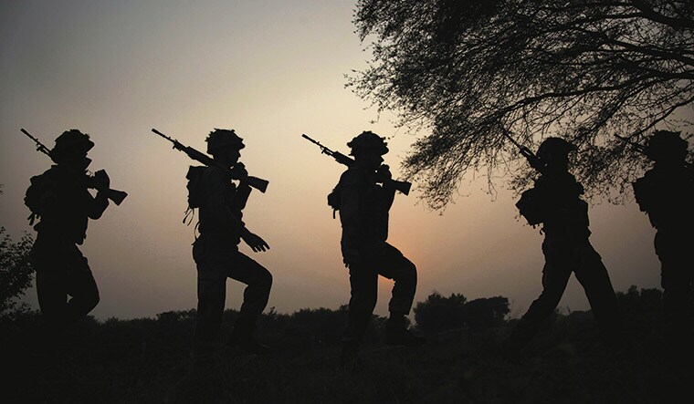 Ready to strike: Indian soldiers patrolling near the Line of Control | AP