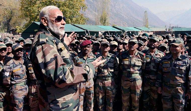 Raring to go: Prime Minister Narendra Modi celebrating Diwali with jawans of the Army and the BSF, in the Gurez Valley, near the Line of Control. Threats from across the border is a recurring theme of the BJP’s poll campaign | PTI
