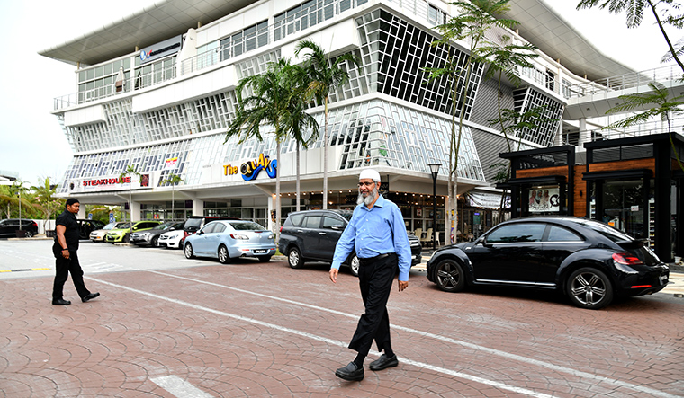 Hopes in exile: Naik outside a mall in Malaysia. He says he would “love to remain an Indian”, though Malaysia has granted him permanent resident status.