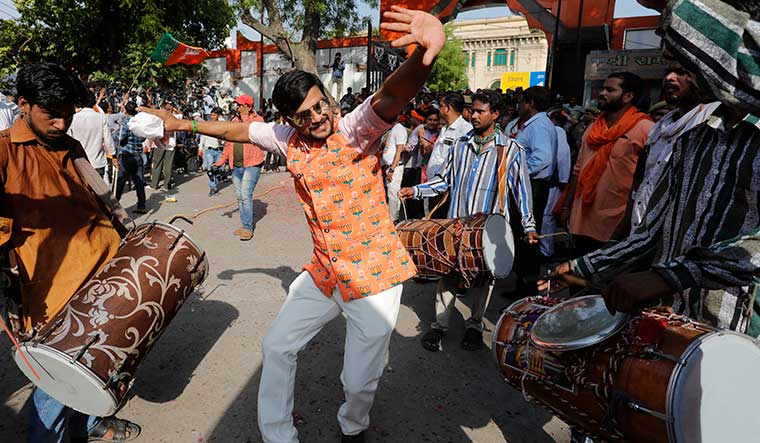 Victor’s dance: A BJP worker celebrates at the party office in Lucknow on the day of the results | Pawan Kumar