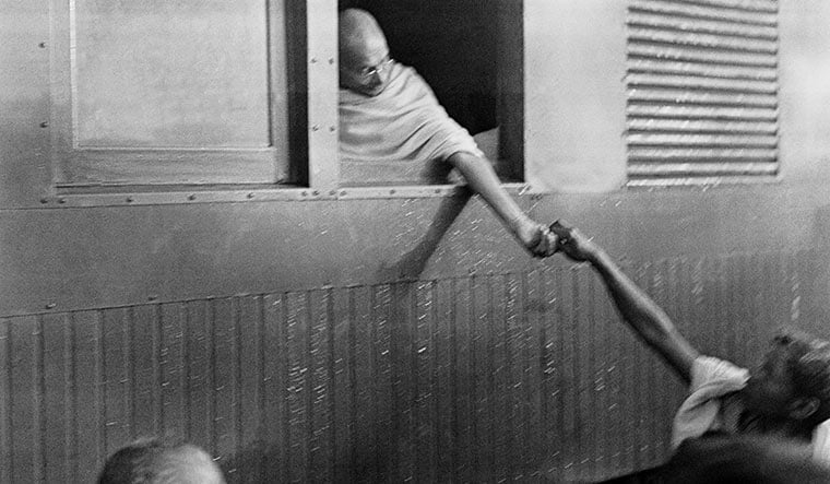 Broken idol: Gandhi collecting donations for harijan fund at a train station in1945 | Dinodia